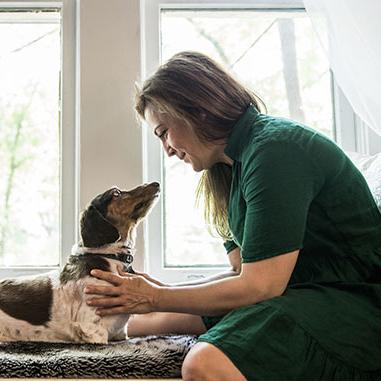 woman petting a dog